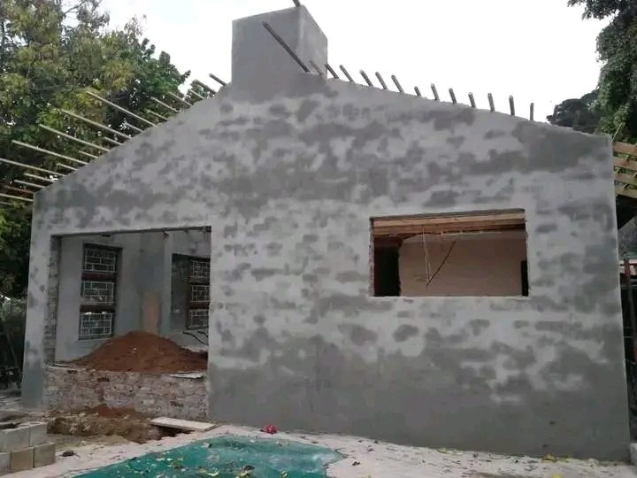 House exterior with fresh cement plaster around window openings