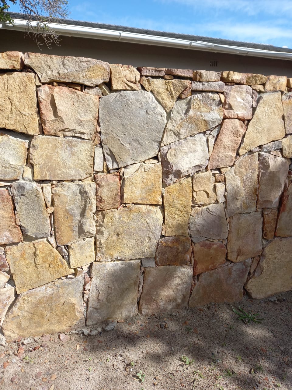 Irregular natural stone wall masonry and mortar joints