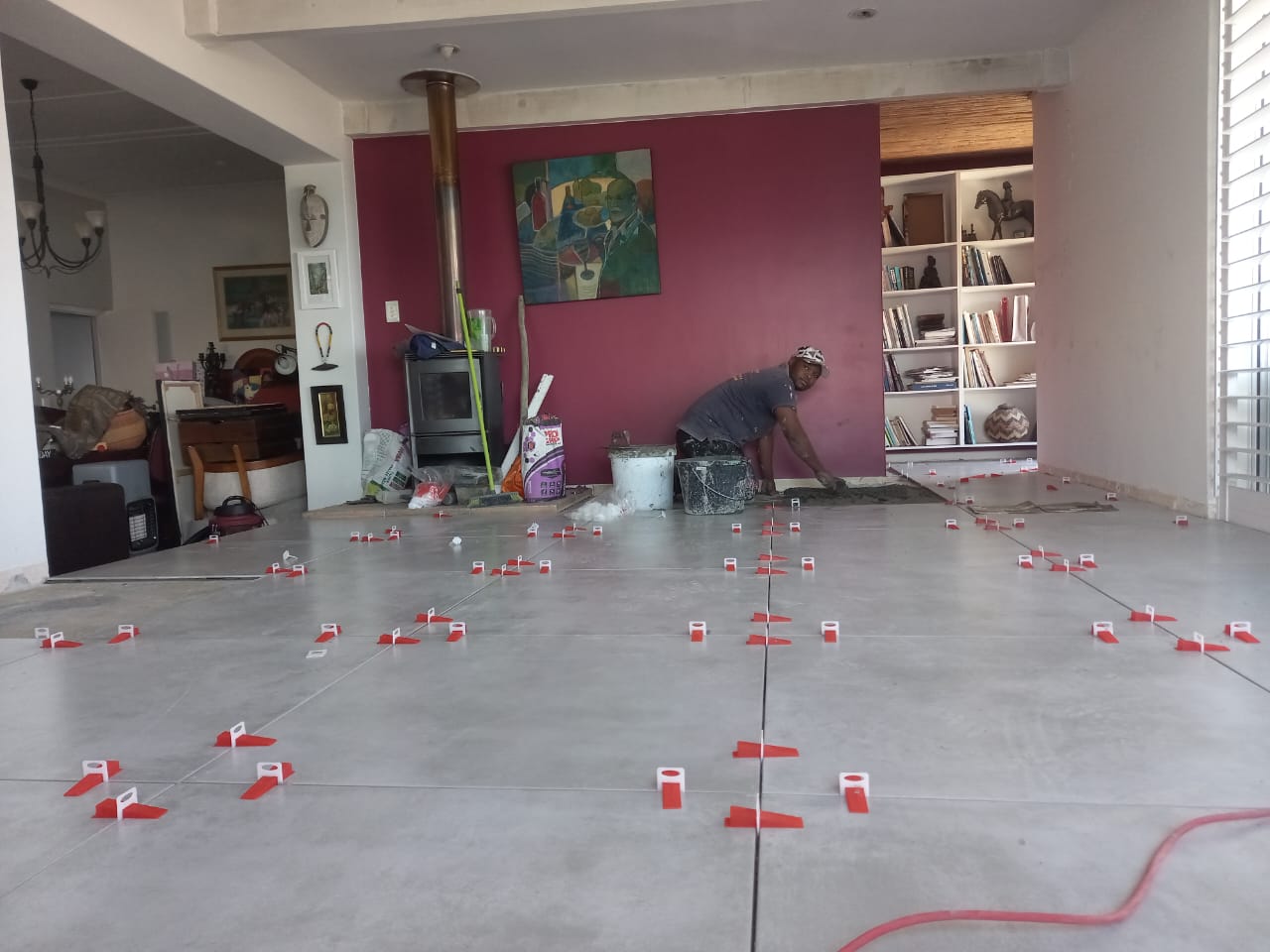 Large grey floor tiles installed with levelling clips