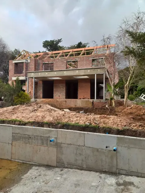 Brick build with roof trusses and new retaining wall