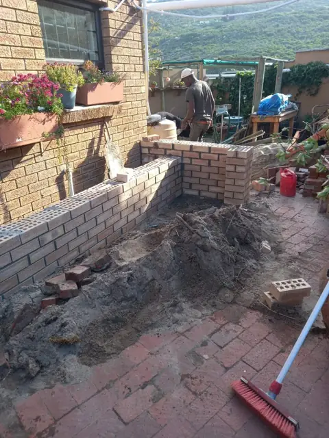 Block boundary wall being built in a garden