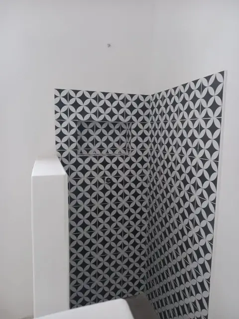 Black and white patterned feature tiling on a wall