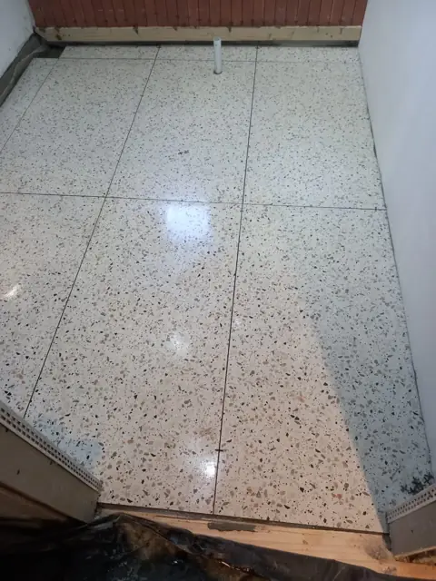 Polished terrazzo tiled floor, large format