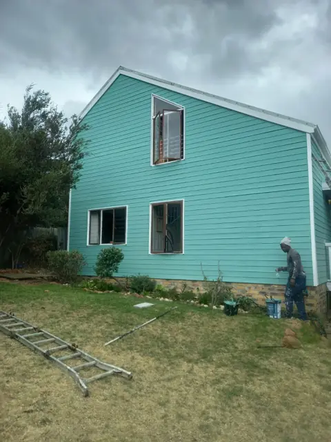 Completed teal painted house exterior