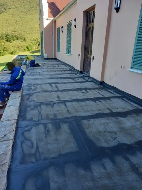 Torch-on waterproofing membrane on a flat balcony walkway
