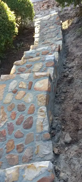 Stone-clad garden steps and retaining wall