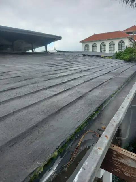 Aged fibre-cement roof sheets needing recoating