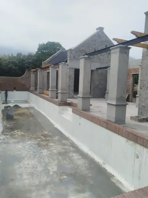 Concrete pool and pillar structure under construction
