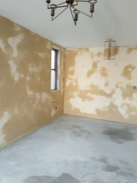 Interior room with freshly skimmed walls and chandelier