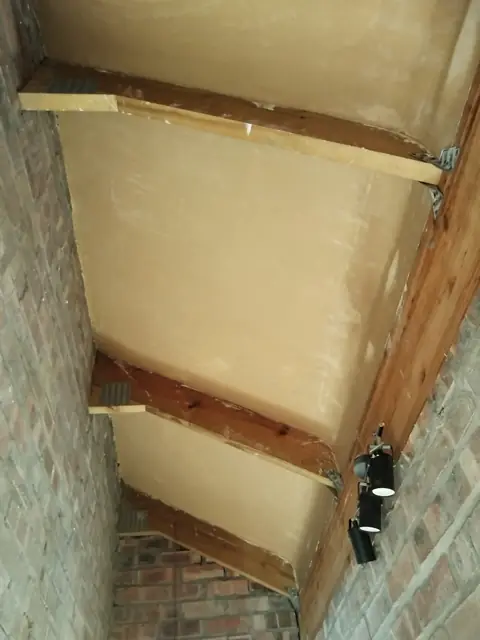 Ceiling boards skimmed between exposed timber beams; alt carpentry