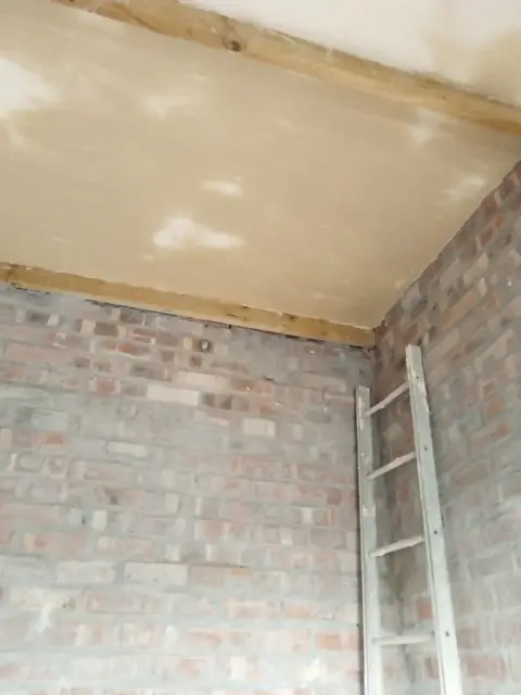 Vaulted skimmed ceiling in progress with ladder