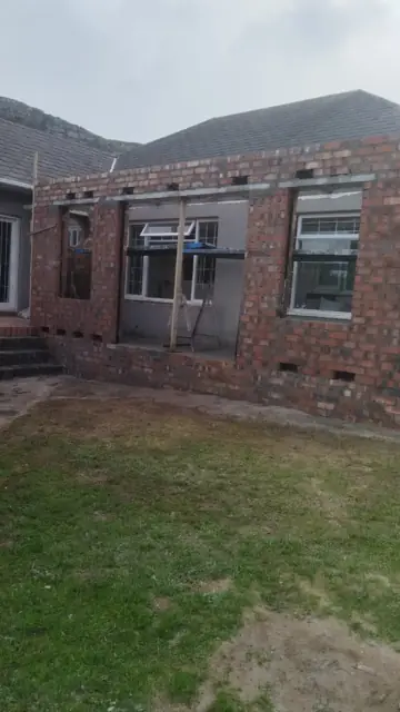 Face-brick extension shell at the rear of a house with window openings