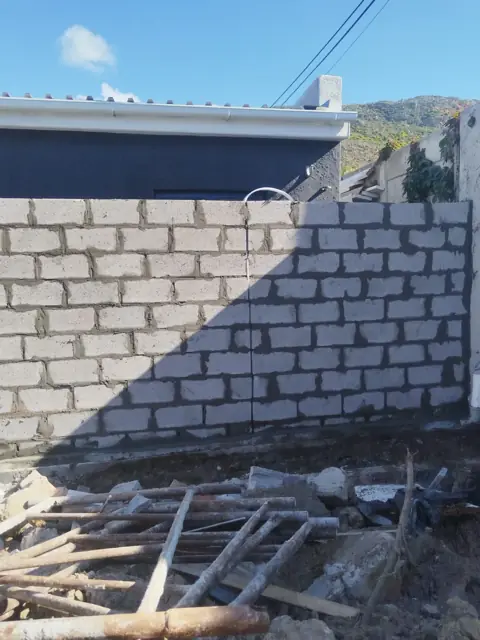 Grey block boundary wall under construction