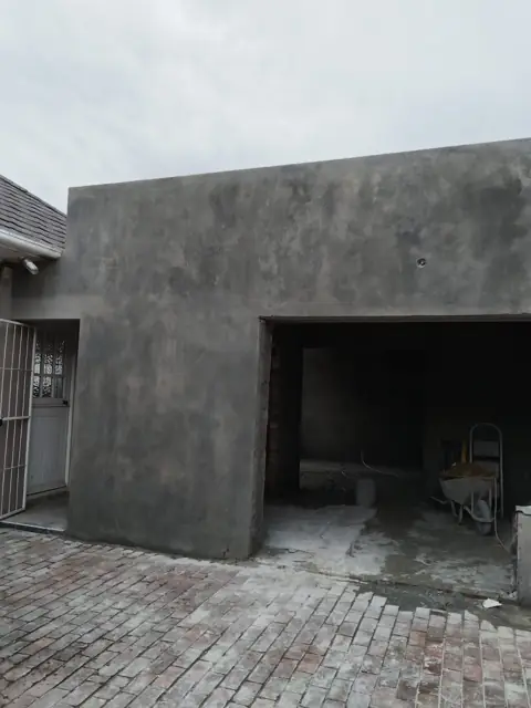 Freshly plastered garage outbuilding in grey plaster