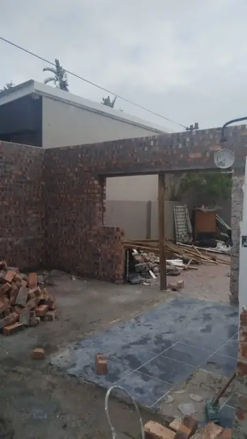 Brick garage walls with door opening and new floor slab
