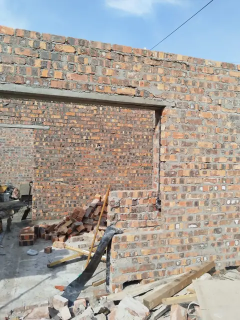 Brick wall with lintel and window opening during construction