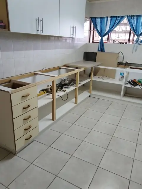 Kitchen refit with base carcasses and white wall cabinets
