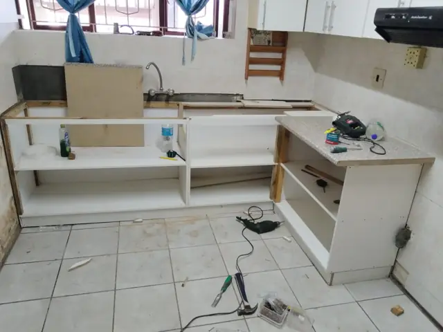 Kitchen base cabinet carcasses during installation with tools
