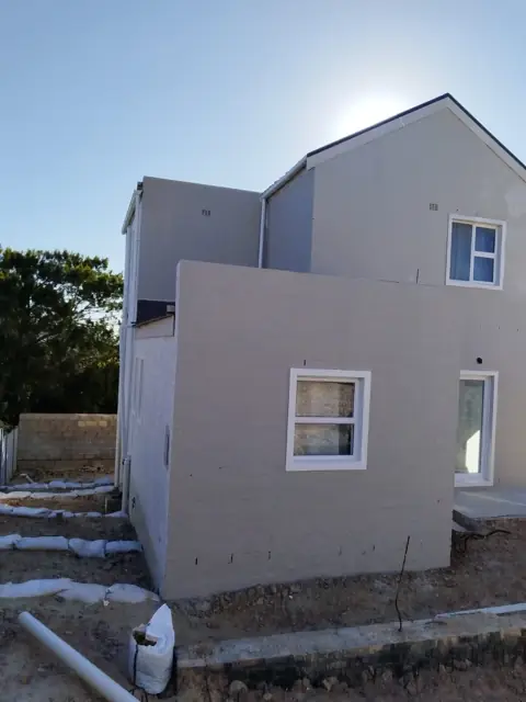 New double-storey build exterior with fresh plaster and paint