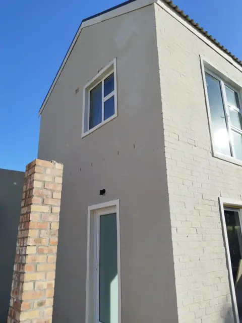 Double-storey new build with face-brick chimney detail