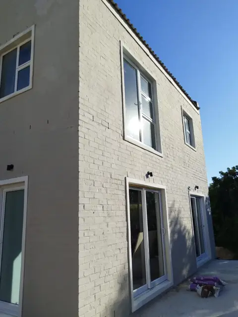 Completed new home exterior, painted brickwork