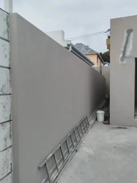 Plastered boundary walls along walkway