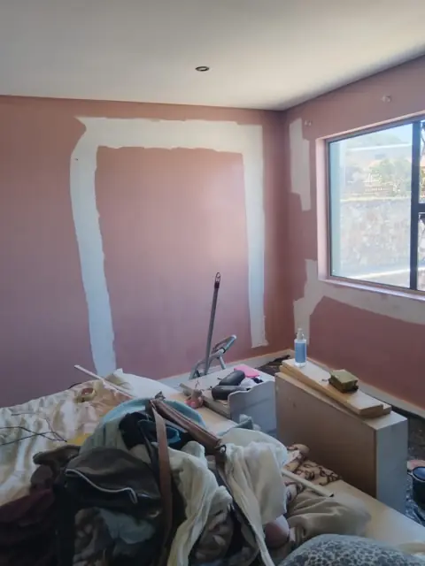 Interior wall prepared and patch-primed for repaint