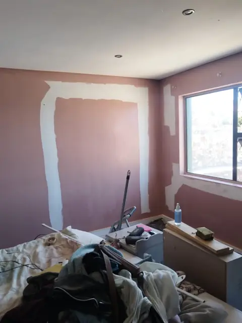Bedroom wall prepped and primed for painting