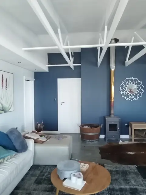 Living room repaint with feature wall and exposed trusses