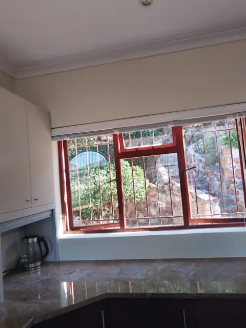 Kitchen interior with timber windows and granite tops