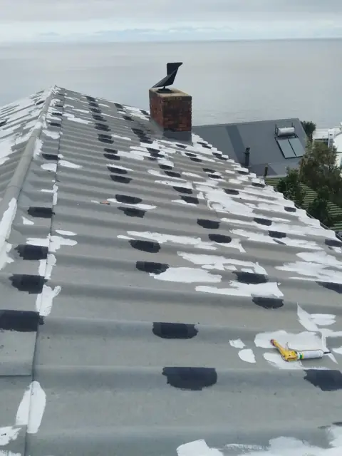 Roof tiles spot-primed before coating, sea view