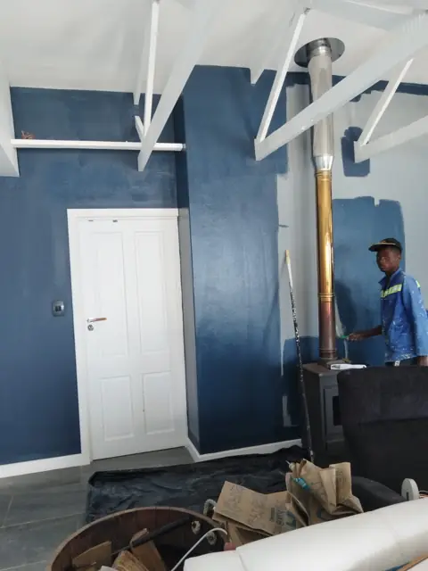 Feature wall painting with exposed roof trusses