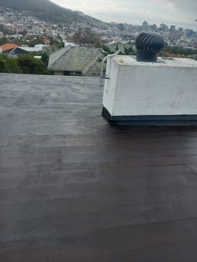 Flat roof with whirlybird vent, coated surface, Cape Town view — waterproofing companies cape town