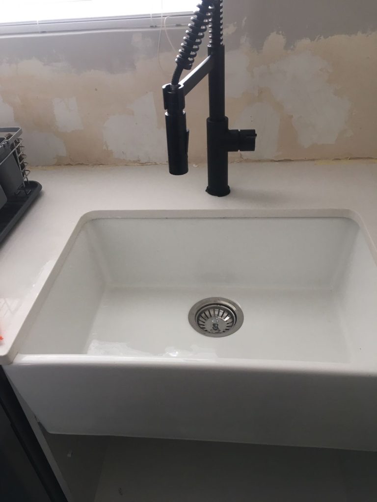 Ceramic butler sink and pull-down mixer installed — plumbing services cape town
