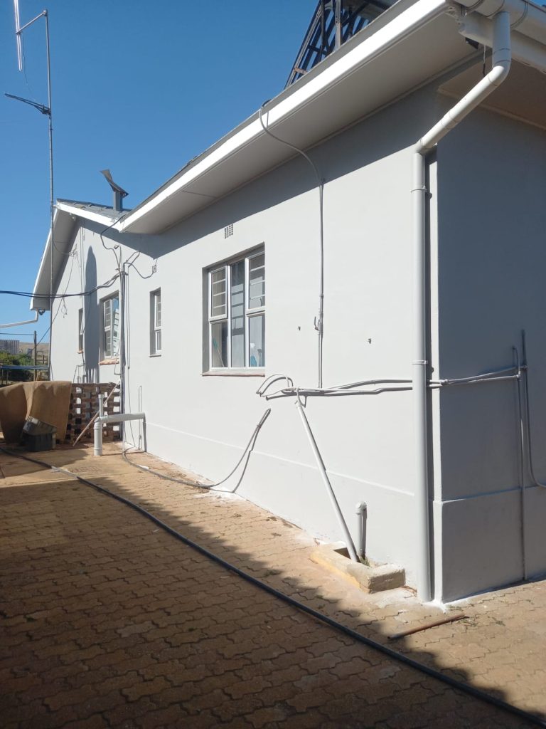 Freshly painted grey house exterior, completed — painting contractors cape town