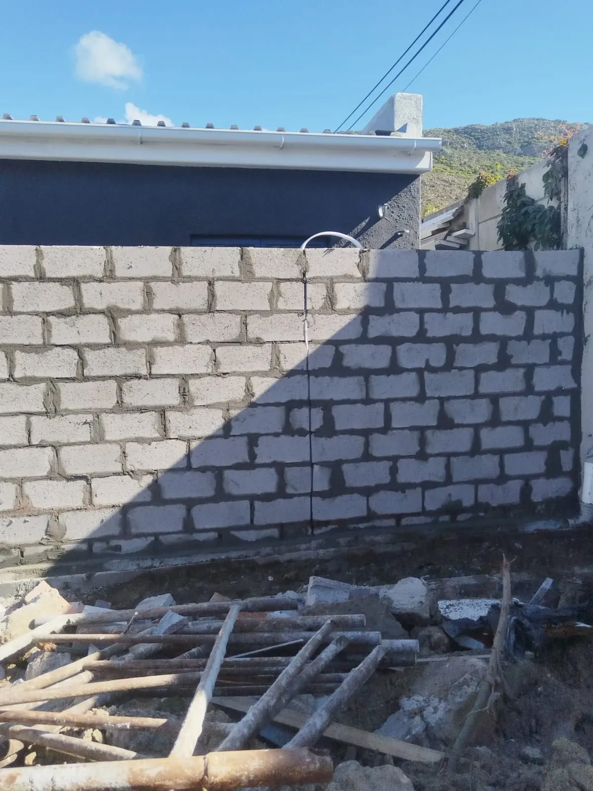 Grey block boundary wall under construction