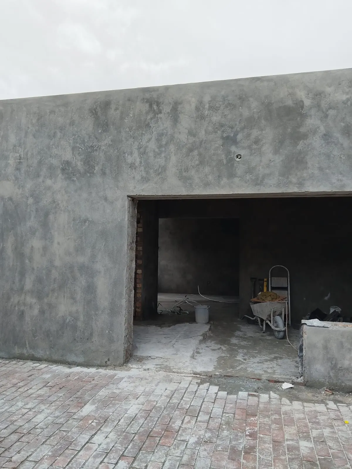 Plastered garage exterior with vehicle opening